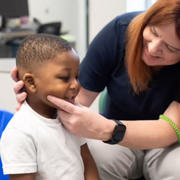 therapist holding boys chin